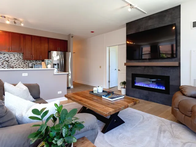 a living room with furniture and a fireplace