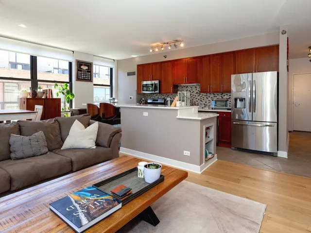 a living room with furniture rug and kitchen view
