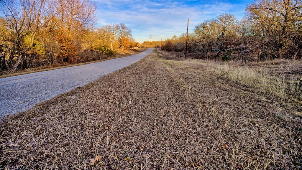 1943 Lakeridge Boulevard Sunset, TX 76270 - Photo 2 of 24 a view of a yard with wooden fence