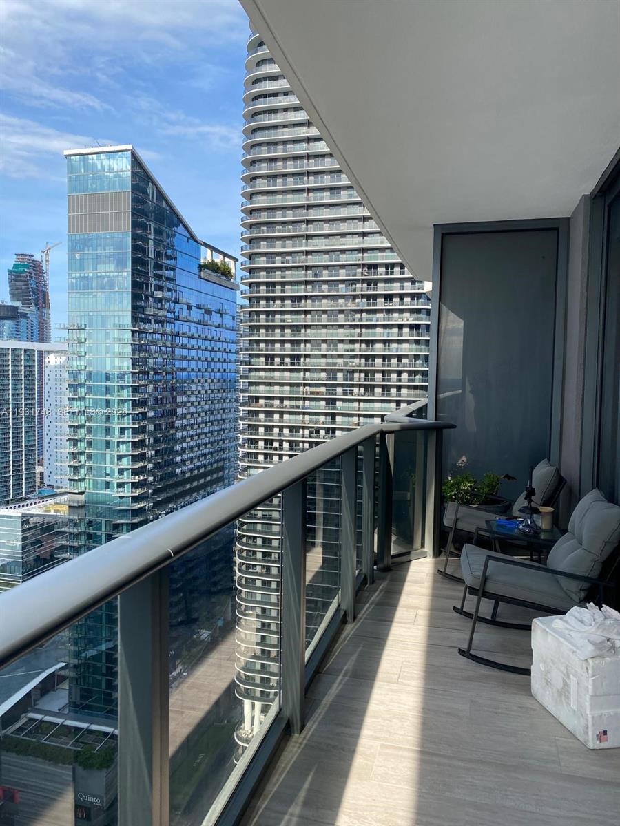 55 Southwest 9th Street, Unit 3609 Miami, FL 33130 - Photo 7 of 21 a view of balcony with wooden floor and outdoor seating
