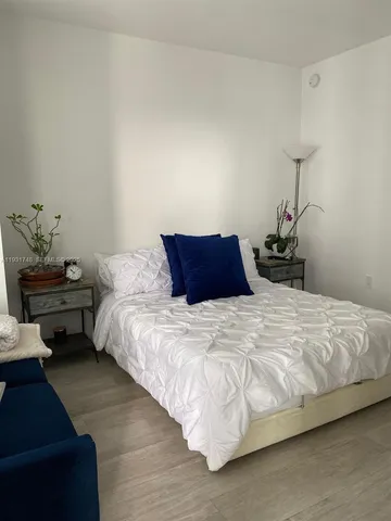 a bedroom with bed and window