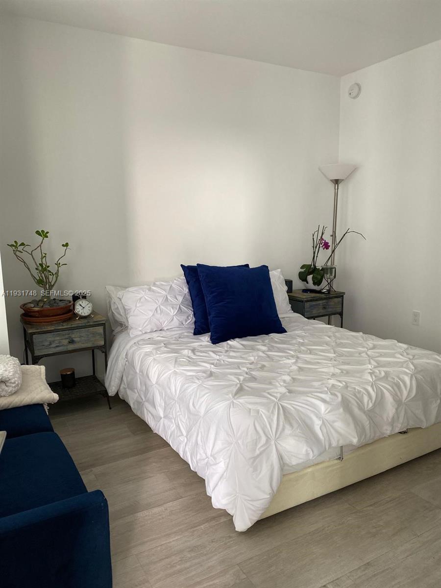 55 Southwest 9th Street, Unit 3609 Miami, FL 33130 - Photo 8 of 21 a bedroom with bed and window