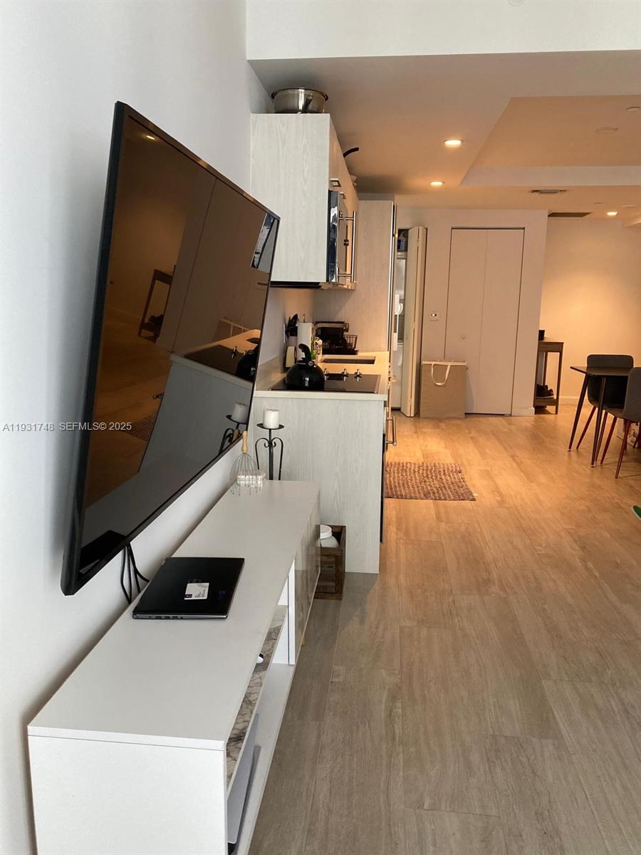 55 Southwest 9th Street, Unit 3609 Miami, FL 33130 - Photo 10 of 21 a living room with furniture and a flat screen tv