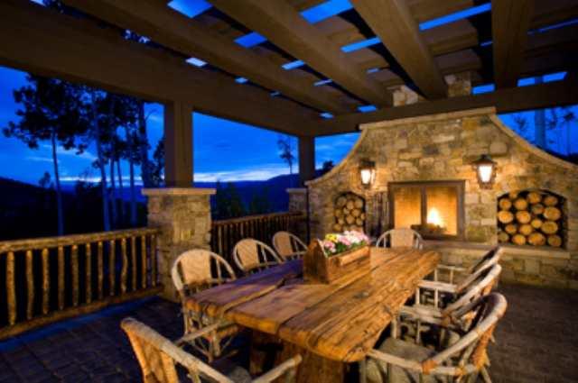 127 Powderbowl Trail Aspen, CO 81611 - Photo 4 of 9 a view of a patio with table and chairs with wooden floor and fence