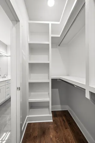 a view of walk in closet with empty racks