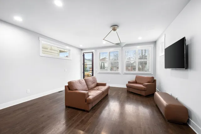 a living room with furniture windows and a flat screen tv