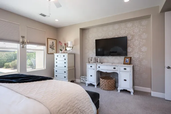 a bedroom with furniture and flat screen tv
