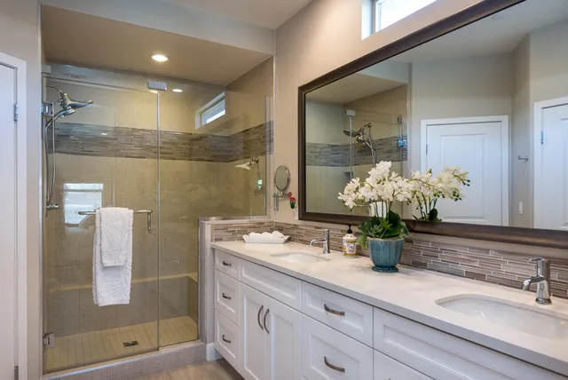 a bathroom with a shower sink and mirror