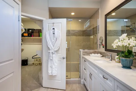 a bathroom with a double vanity sink toilet and shower