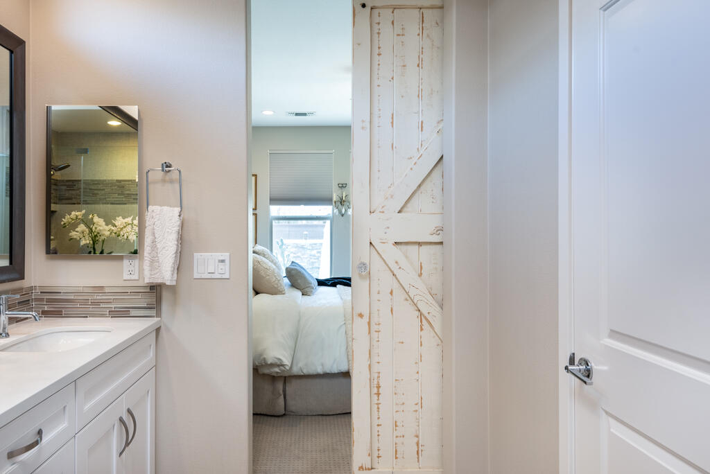 82803 Spirit Mountain Drive Indio, CA 92201 - Photo 14 of 30 a en suite bathroom with a sink and mirror
