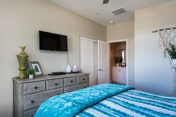 a bedroom with a bed and a flat screen tv