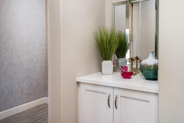 a bathroom with a sink a potted plant and a window
