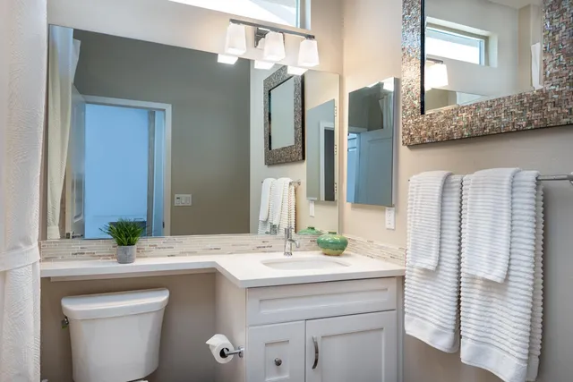 a bathroom with a double vanity sink and a mirror
