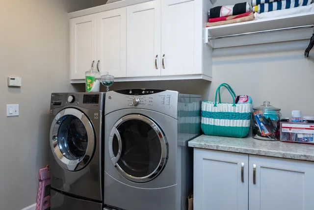 a utility room with sink dryer and washer