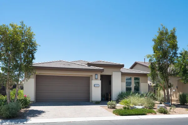 a front view of a house with a garden
