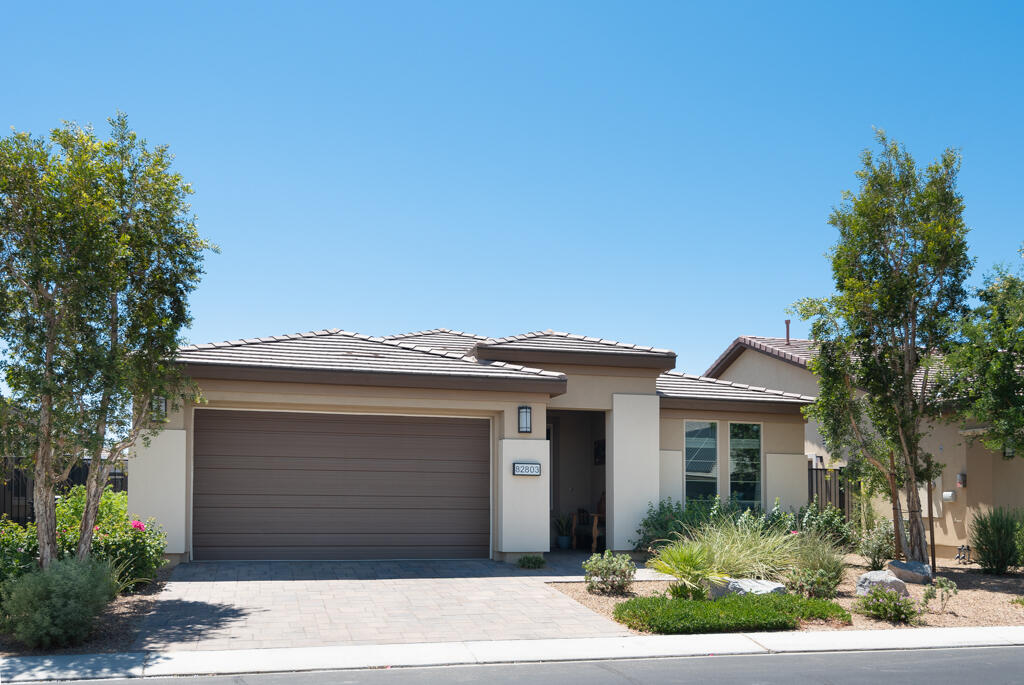 82803 Spirit Mountain Drive Indio, CA 92201 - Photo 2 of 30 a front view of a house with a garden