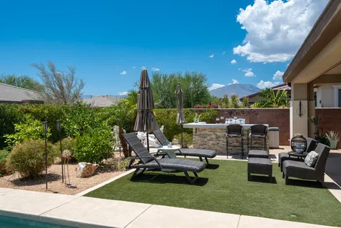 a view of a patio with table and chairs potted plants with wooden floor and fence