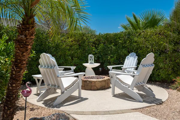a view of a chairs and table in a balcony
