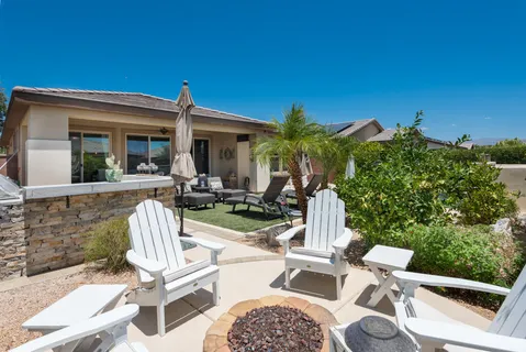 a view of a patio with a table chairs and a fire pit