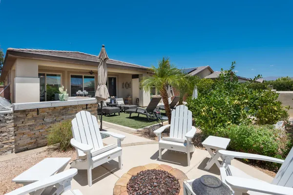 a view of a patio with a table chairs and a fire pit