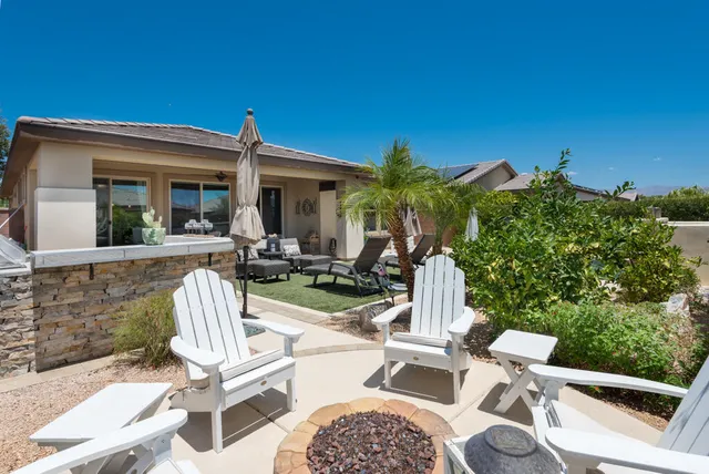 a view of a patio with a table chairs and a fire pit