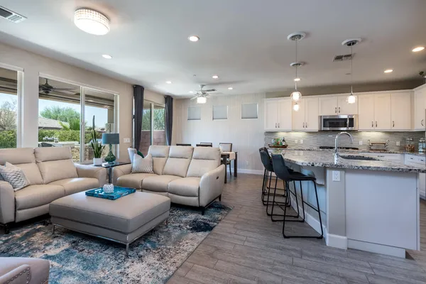 a living room with furniture and kitchen view