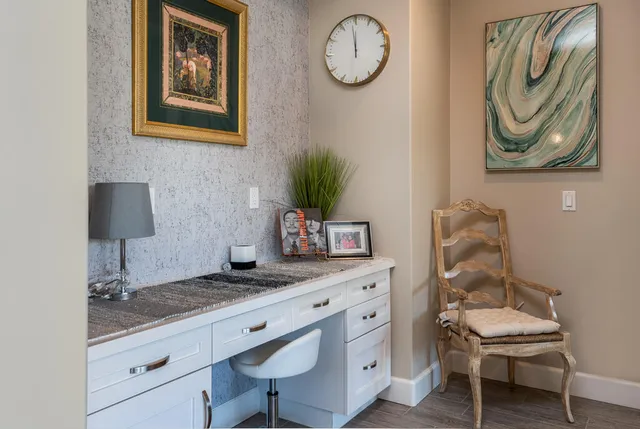 a hallway with painting on wall and a mirror