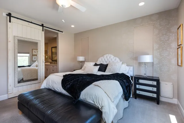 a bedroom with a bed and a chandelier