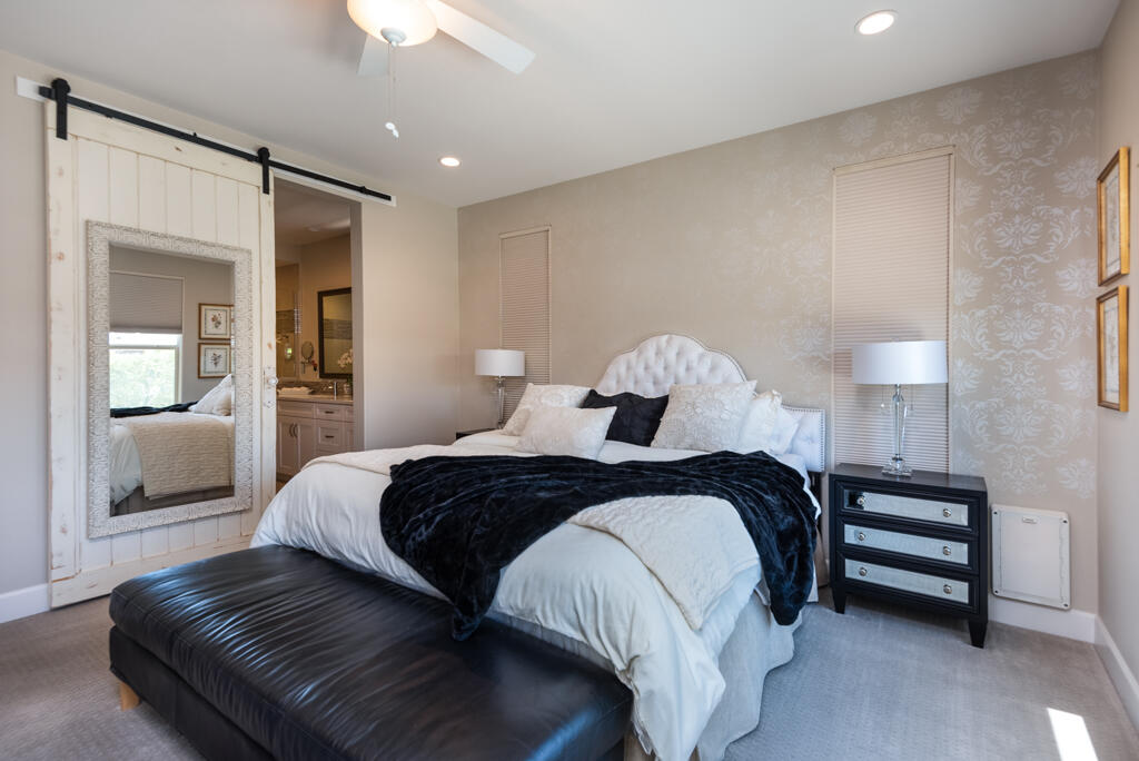 82803 Spirit Mountain Drive Indio, CA 92201 - Photo 10 of 30 a bedroom with a bed and a chandelier
