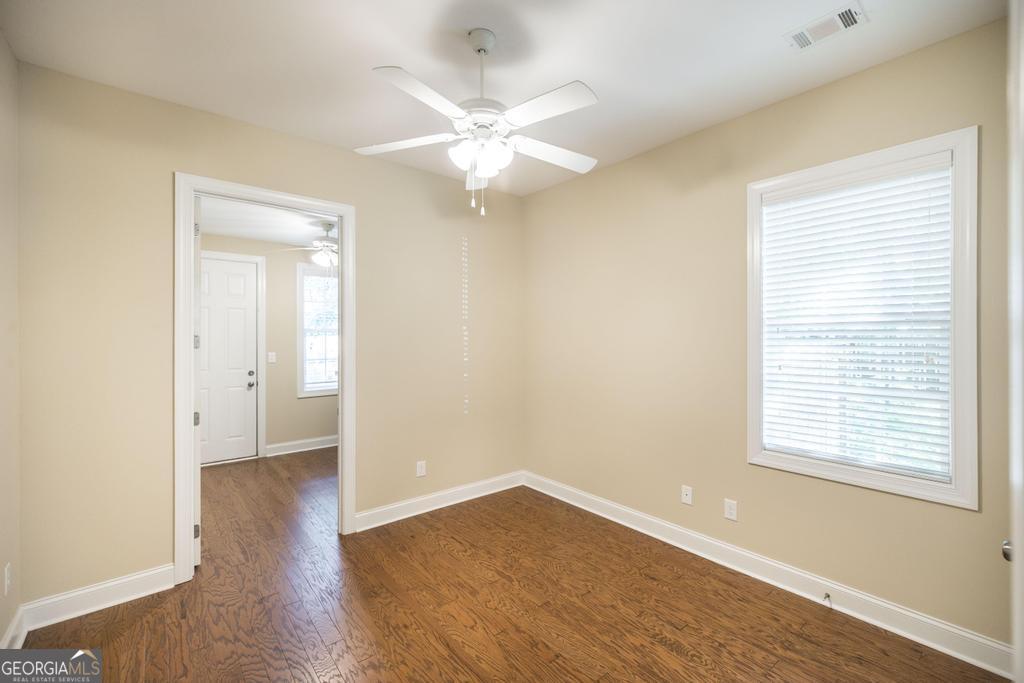 206 Londe Lane Perry, GA 31069 - Photo 26 of 37 a view of an empty room with wooden floor and a window