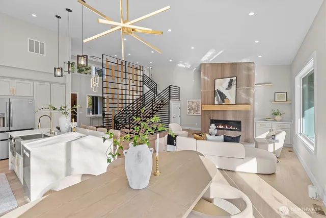 a living room with furniture a fireplace and a chandelier