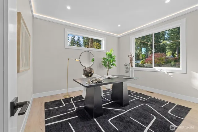 a workspace with wooden floor and windows