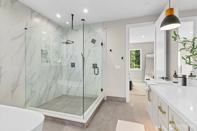 a spacious bathroom with a shower and a sink