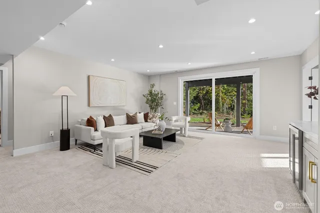 a living room with furniture and large windows