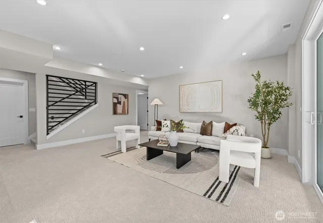 a living room with furniture a window and a potted plant