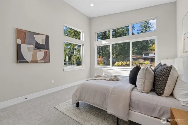 a bedroom with a bed and a large window