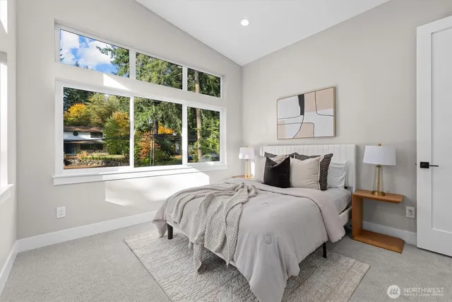 a bed sitting in a bedroom next to a window