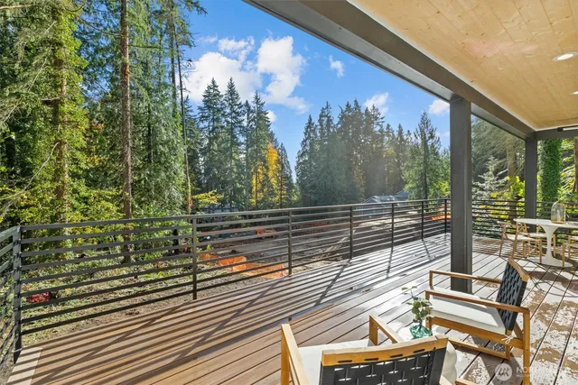 a view of a balcony with a floor to ceiling window and wooden floor