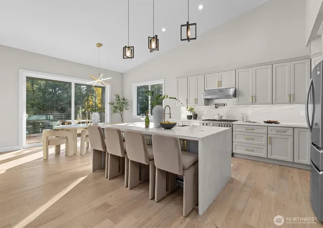 a kitchen with a table chairs sink and cabinets