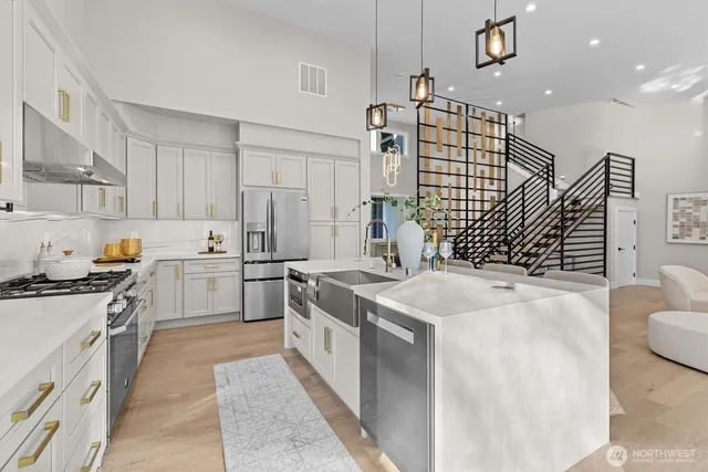 a kitchen with a stove a sink and a refrigerator