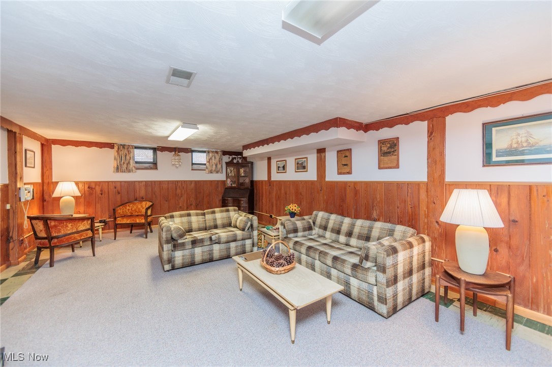 6192 Stanbury Road Parma, OH 44129 - Photo 47 of 49 Living room with wooden walls, wainscoting, and carpet flooring
