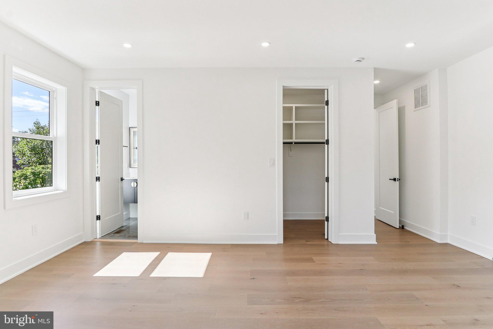 5419 Kempsville Street Springfield, VA 22151 - Photo 29 of 45 a view of an empty room with wooden floor and windows