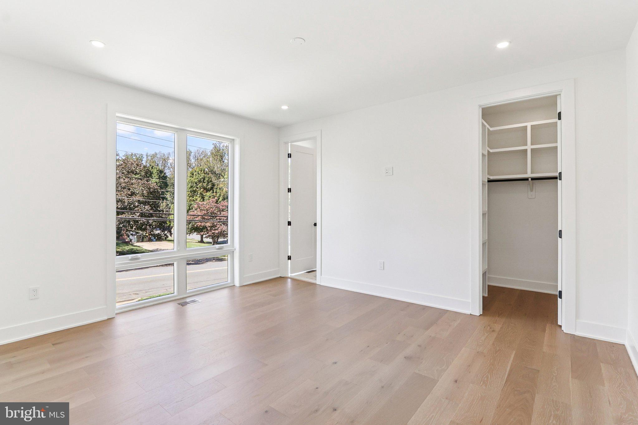 5419 Kempsville Street Springfield, VA 22151 - Photo 32 of 45 an empty room with wooden floor and windows