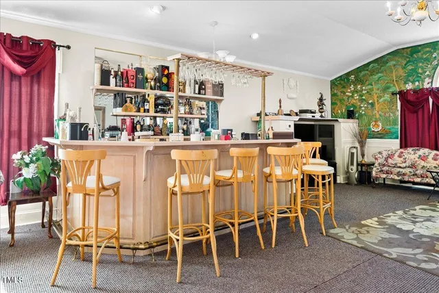 a bathroom with a sink a toilet and shower a mirror