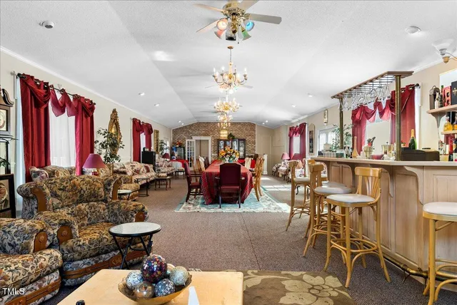 a view of a living room and a porch with furniture