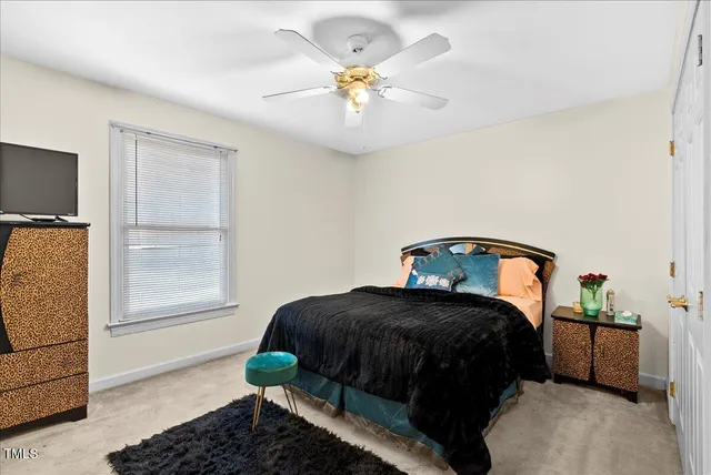 a bed room with furniture and a flat screen tv