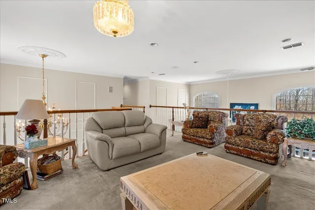 a living room with a table chairs and a flat screen tv