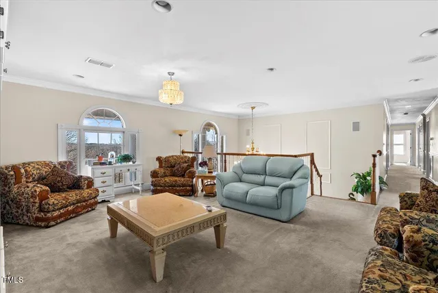a dining area with stainless steel appliances kitchen island granite countertop a table chairs and a refrigerator