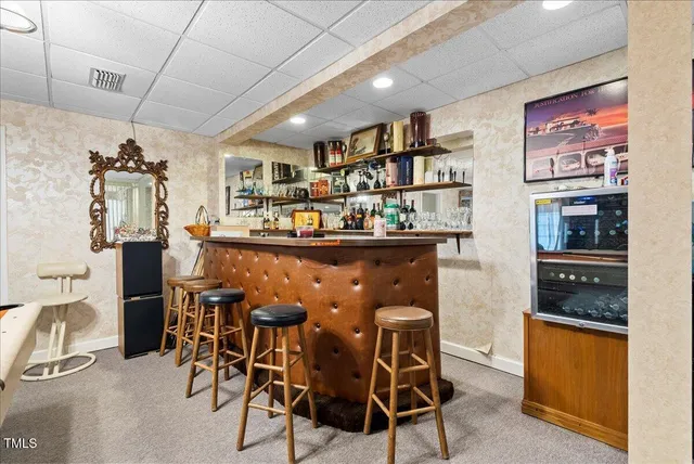 a bedroom with a bed couch and a large window