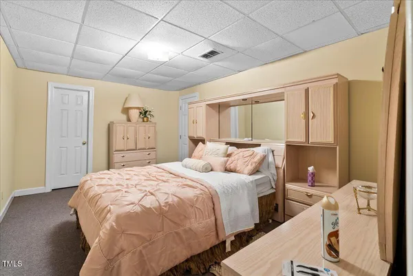 a view of a large white house with a yard covered in snow